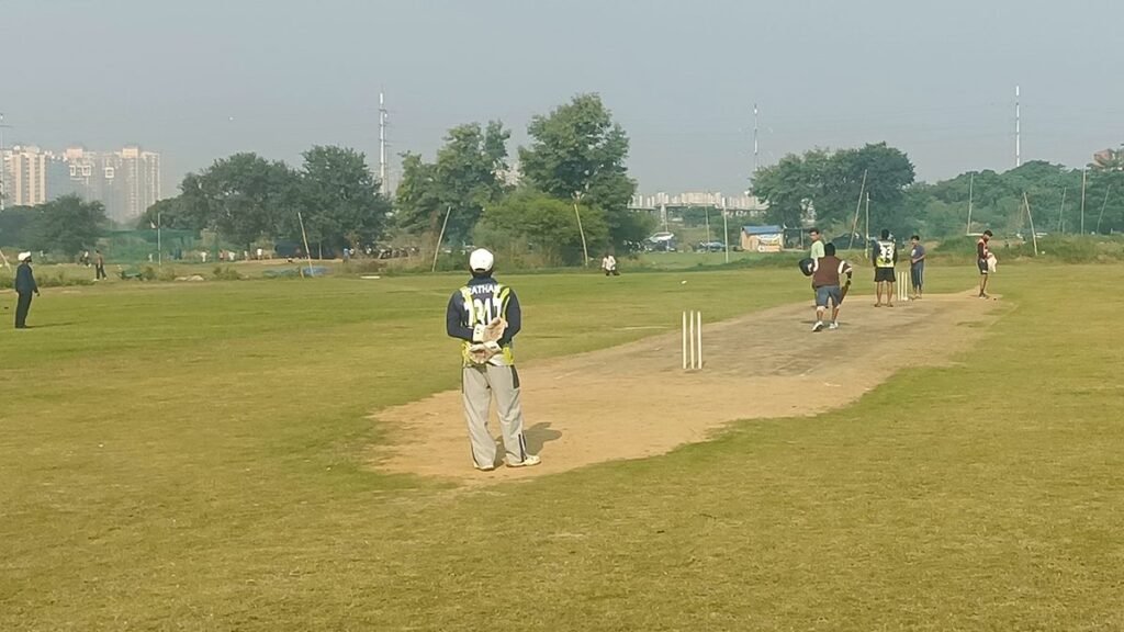 Bowler running in to bowl in an amateur tennis-ball cricket match