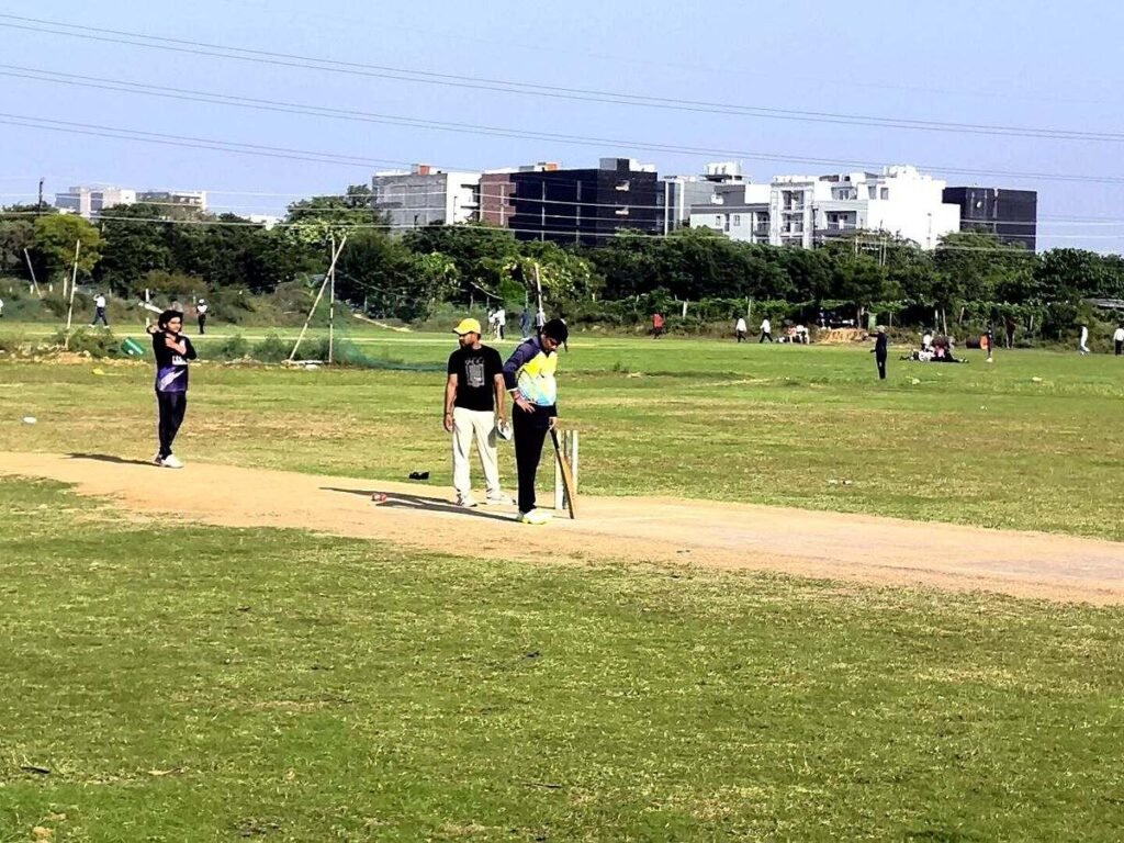 Batter taking guard at the crease during a Sunday 20-over amateur cricket match